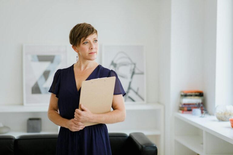 A Woman in Blue Dress Holding a Clipboard